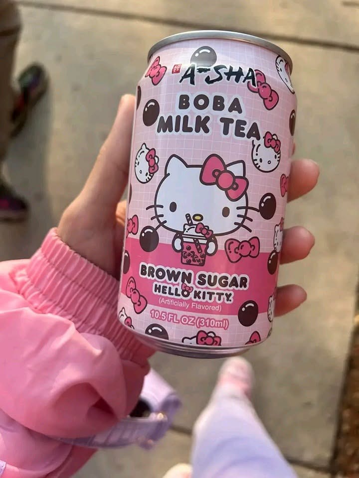 Молочный чай с Hello Kitty Розовая банка молочного чая с тапиокой и изображением Hello Kitty в руке